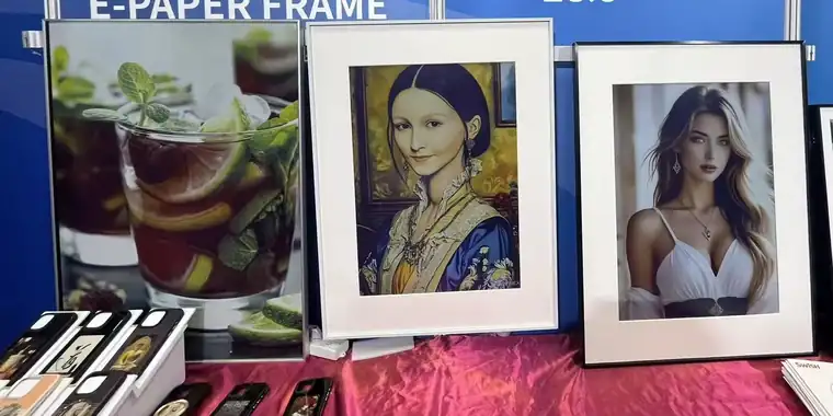 Colour E-Paper frames showing artwork and photography at a product booth